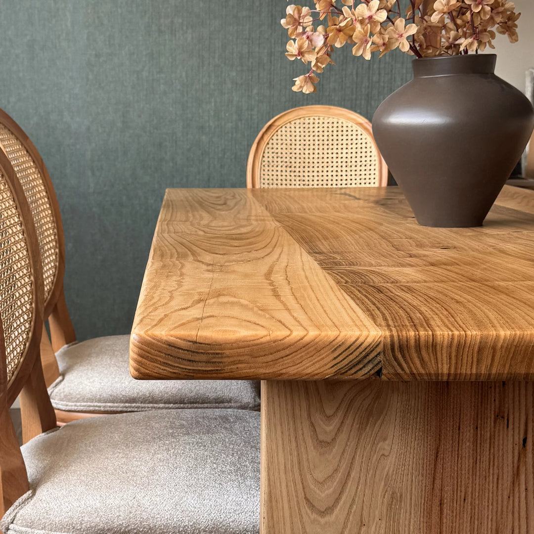 Natural wood dining table — solid chestnut with preserved knots and panel base