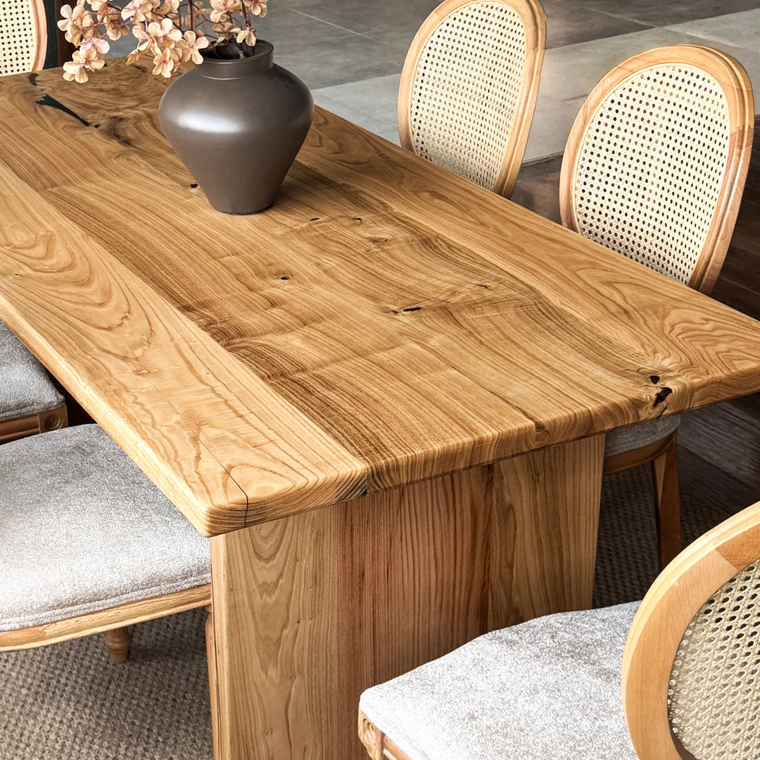 Natural wood dining table — solid chestnut with preserved knots and panel base