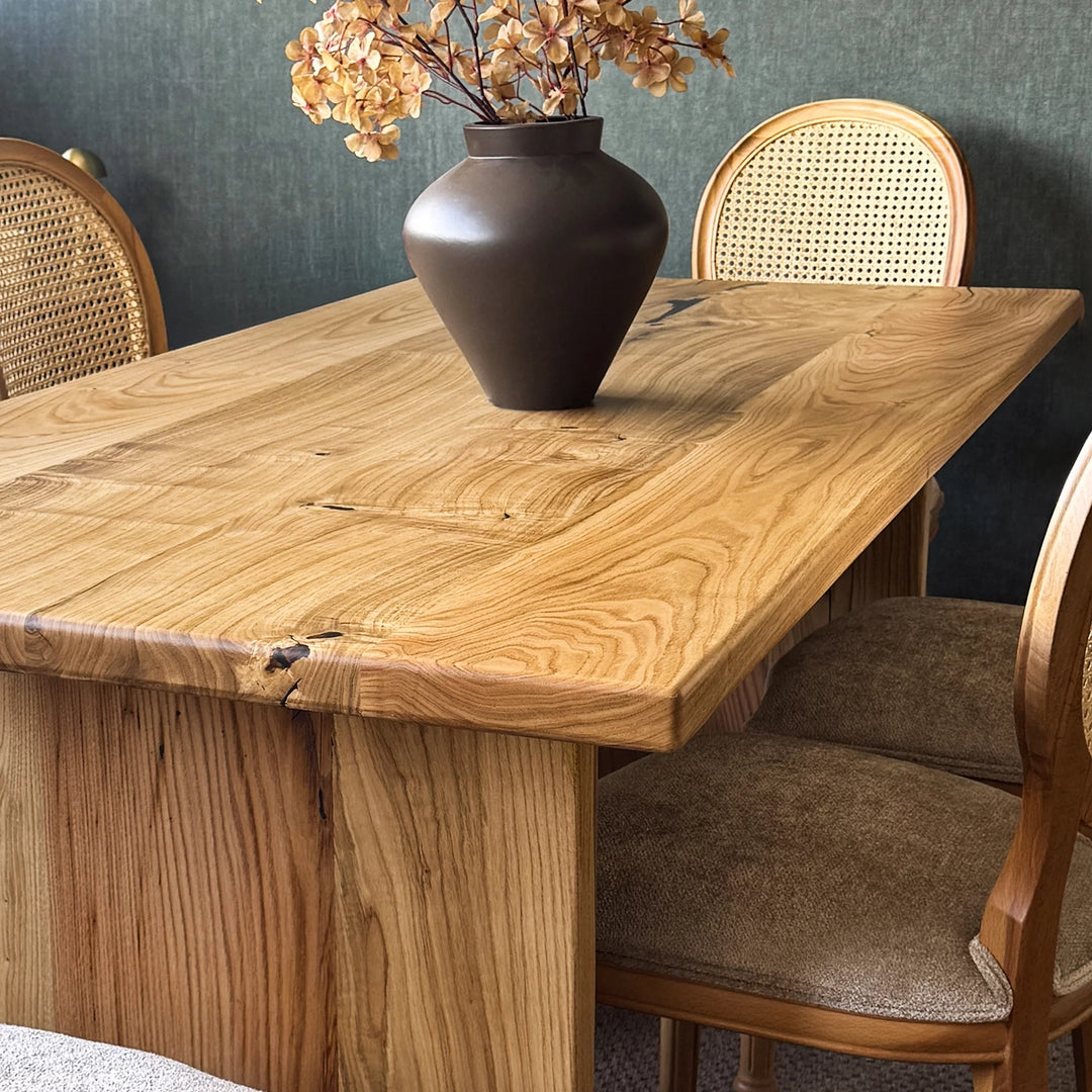 Natural wood dining table — solid chestnut with preserved knots and panel base