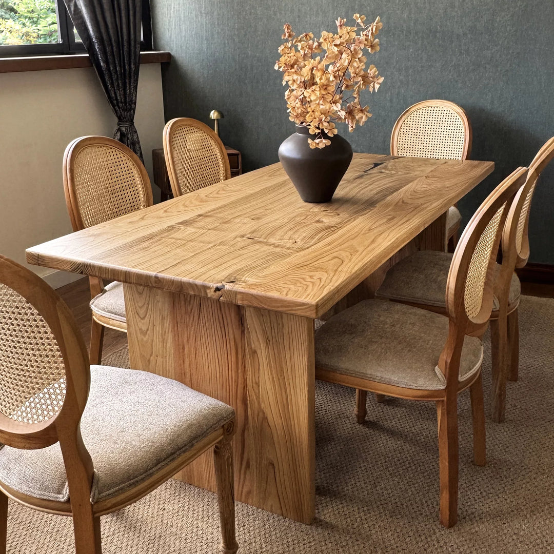 Natural wood dining table — solid chestnut with preserved knots and panel base
