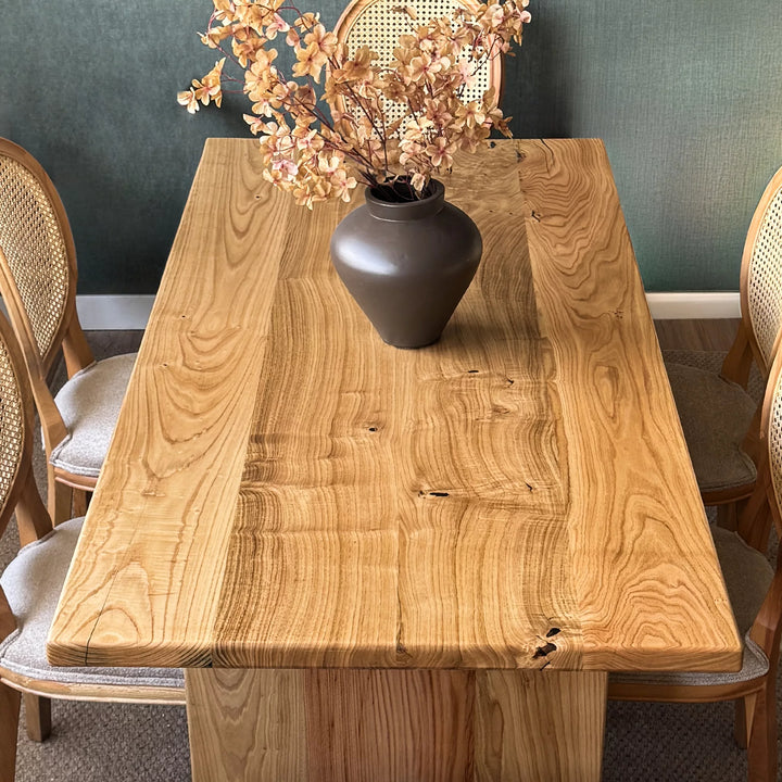 Natural wood dining table — solid chestnut with preserved knots and panel base