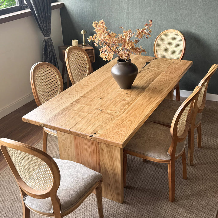 Natural wood dining table — solid chestnut with preserved knots and panel base