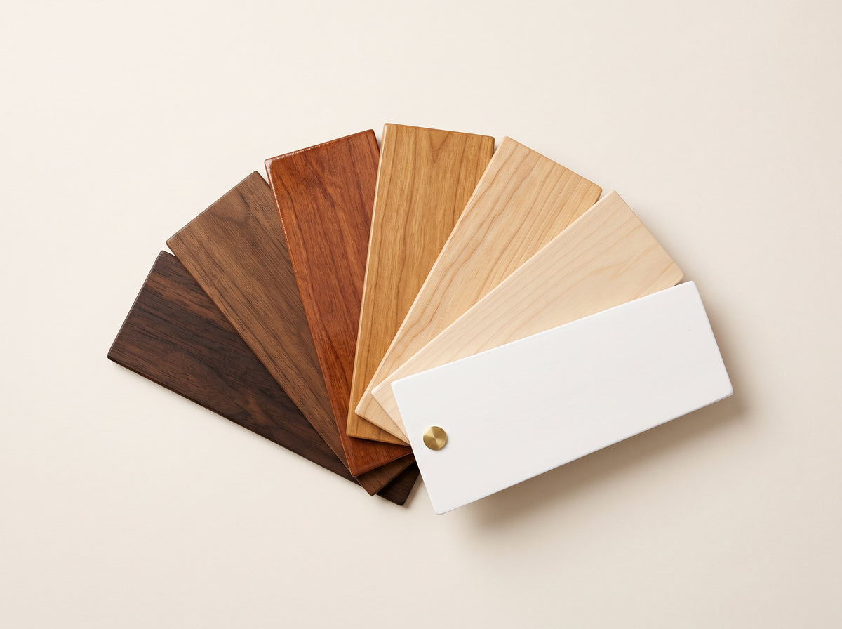 Fan of wood finish samples from a dark walnut stain to light natural wood and white lacquer