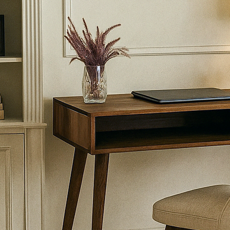 Wooden desk with a vase of dried plants and a tablet on a neutral wall background