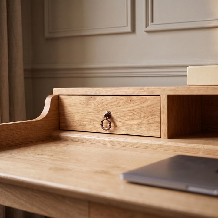 Elegant wooden writing desk with turned legs, small top drawers, and center drawer for home office study spaces   