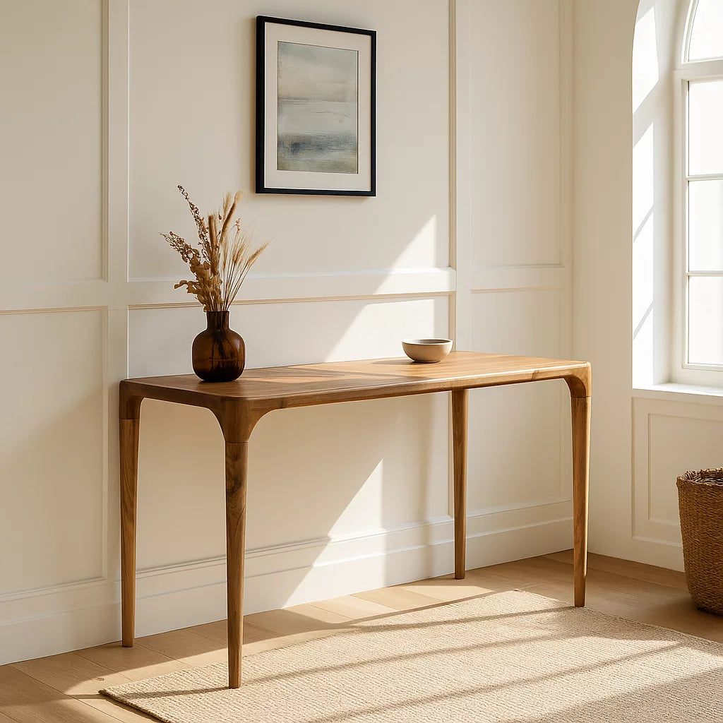 Walnut console table angled in a room corner next to a window, a vase on top