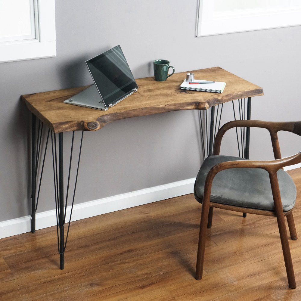 Live edge walnut desk with hairpin legs seen from the left, an open laptop on top