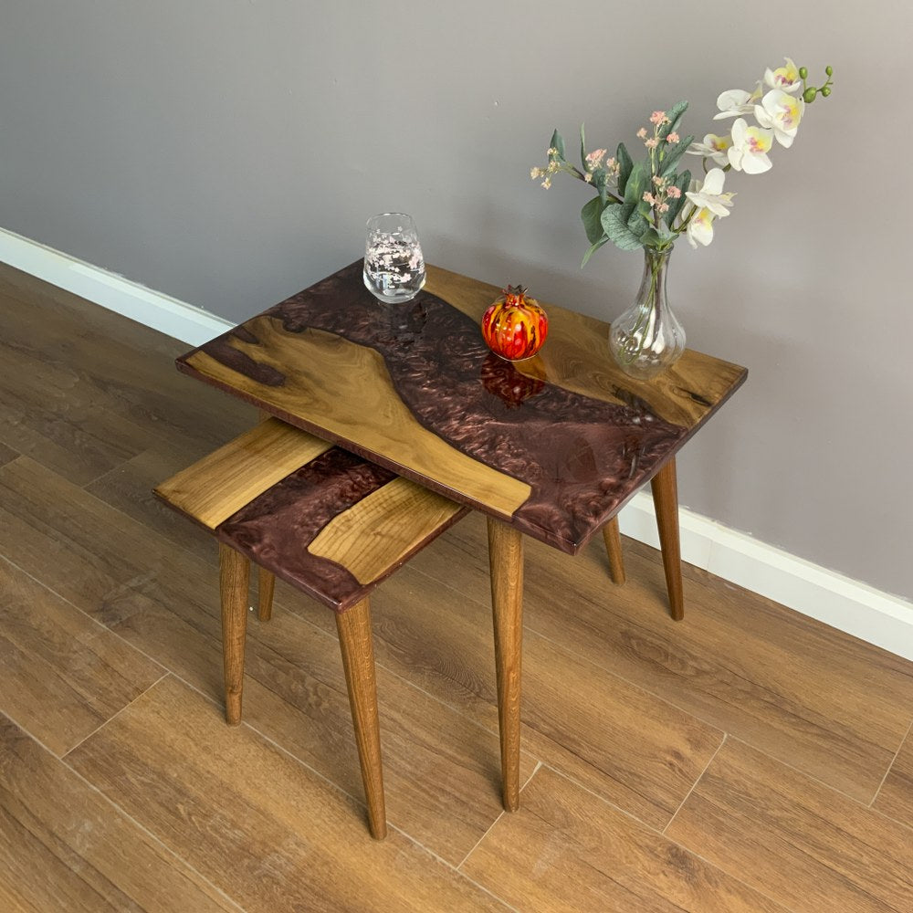 Walnut nesting tables set at an angle with the small table pulled out toward the front right