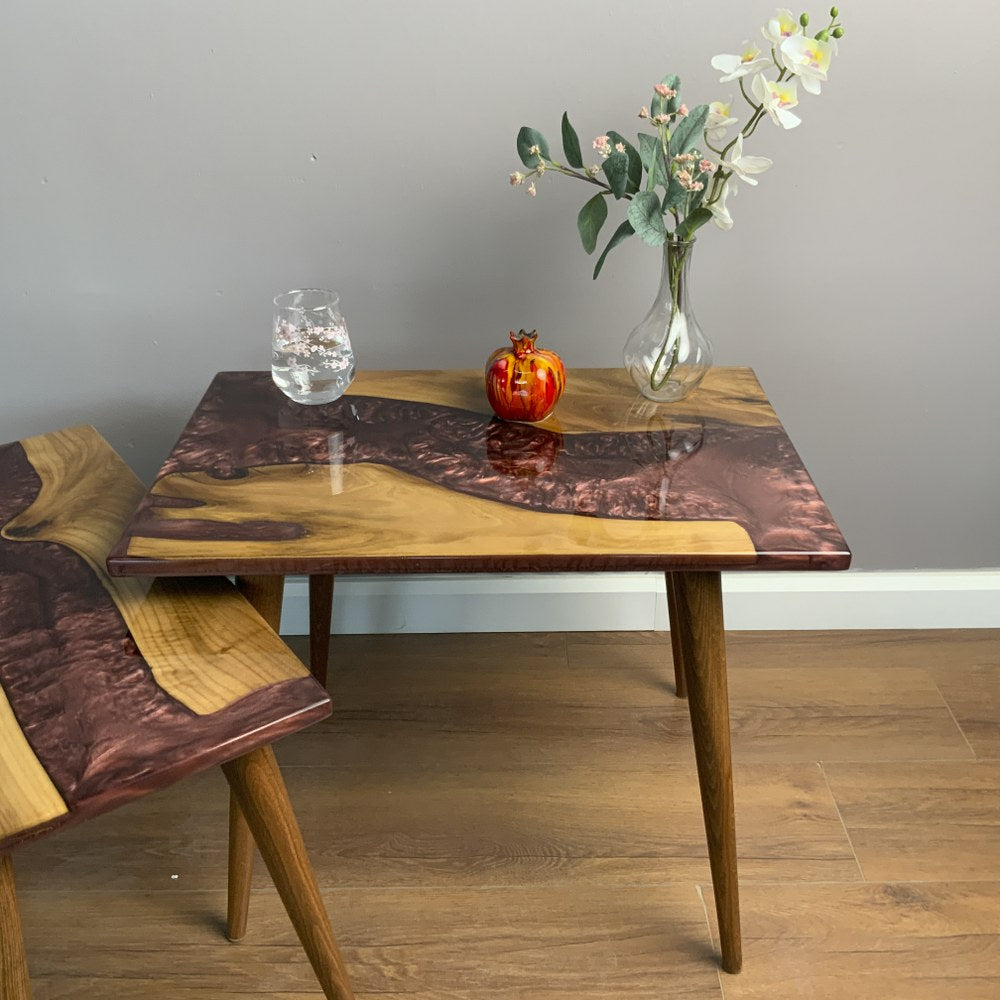 Burgundy river walnut nesting table seen from a low front angle with the small table at the left foreground