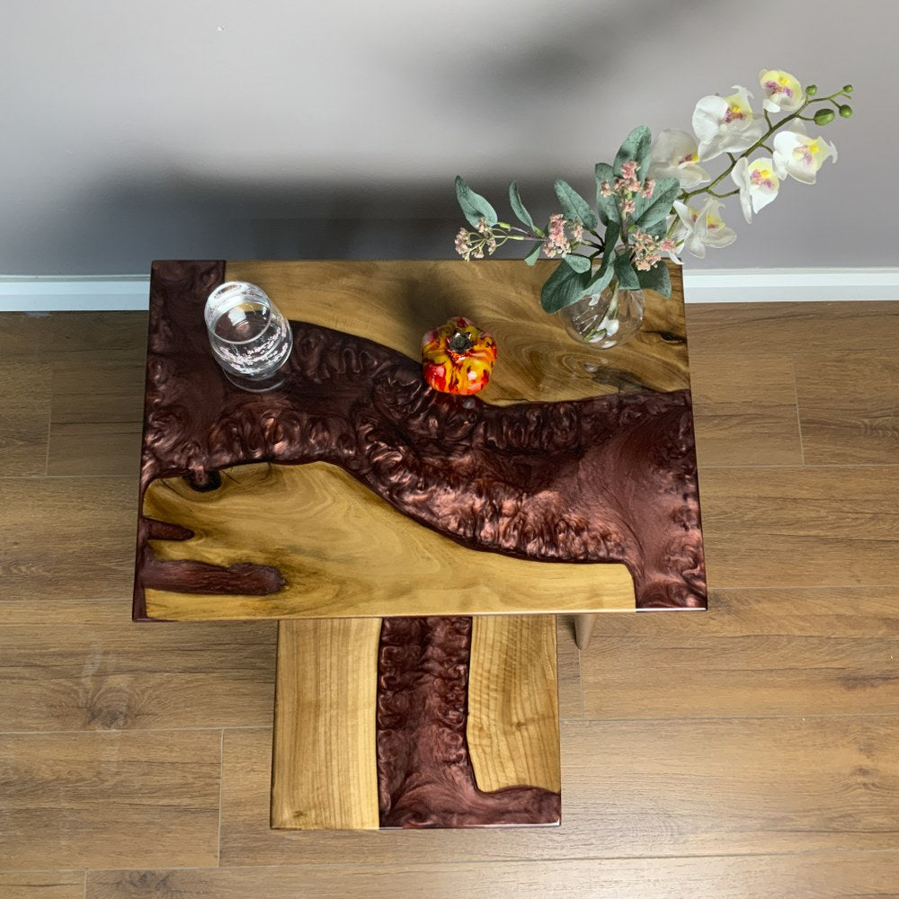 Top view of the burgundy epoxy river on the large walnut nesting table with the small table below
