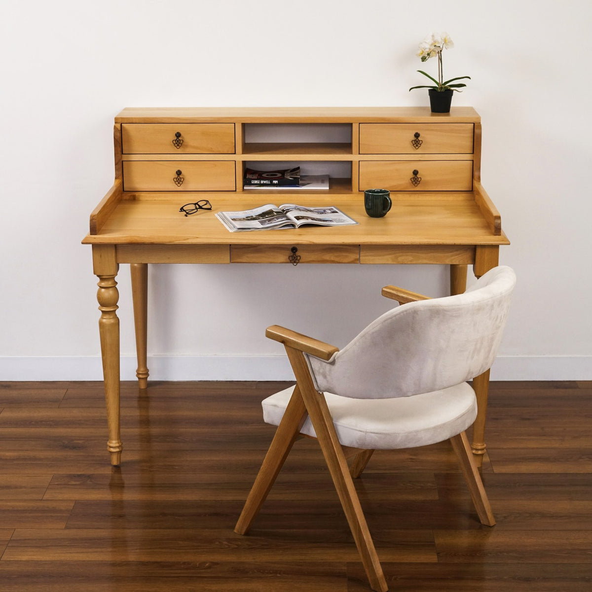 Solid beech writing desk with a drawer hutch and turned legs, front view with an upholstered chair