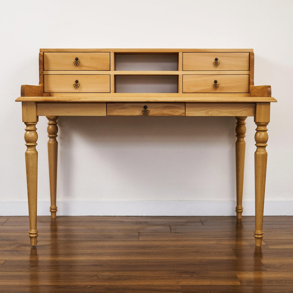 Beech writing desk with hutch drawers seen straight from the front, showing the center drawer under the top