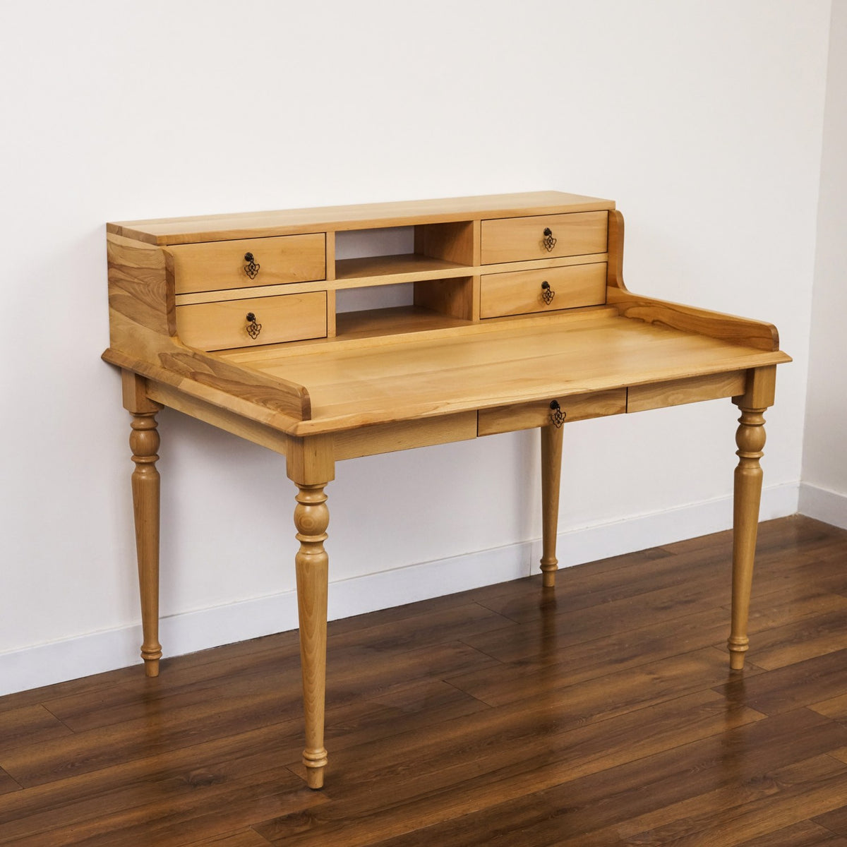 Beech writing desk with hutch viewed from the left corner, showing the turned legs and rear gallery