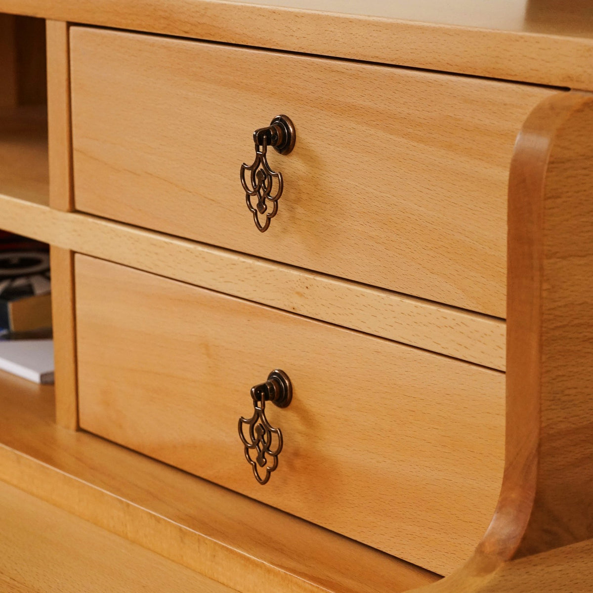 Close-up of two hutch drawers with antique-style drop pulls on the beech writing desk