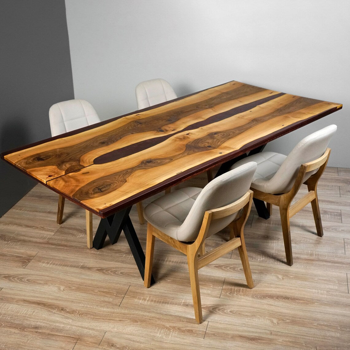 Live edge walnut dining table with burgundy epoxy river, front-left view with four upholstered chairs