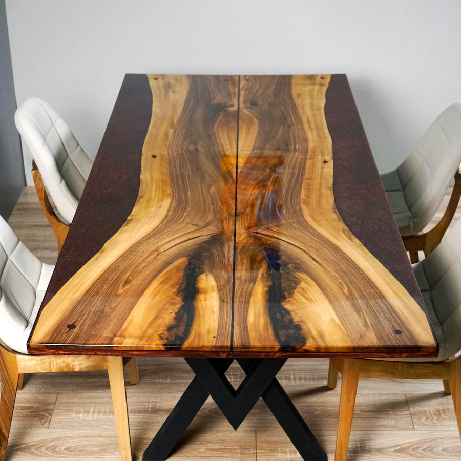 Front top view of the walnut dining table showing live edge center slabs and burgundy resin sides
