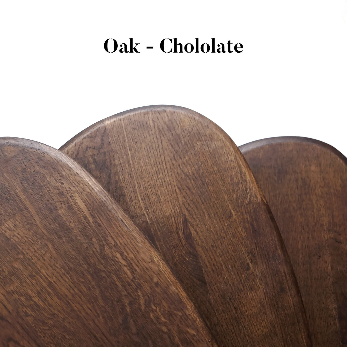 Close-up of overlapping chocolate oak nesting table tops with a color label