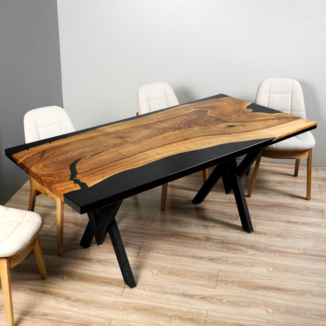 Long side angle of the live edge walnut dining table with black epoxy top and metal legs