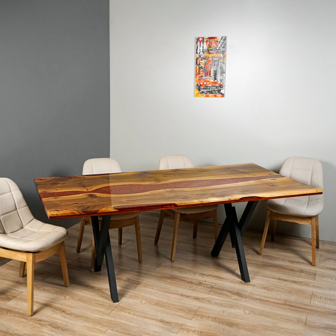 Side view of the live edge walnut dining table with burgundy epoxy river and X-shaped metal legs