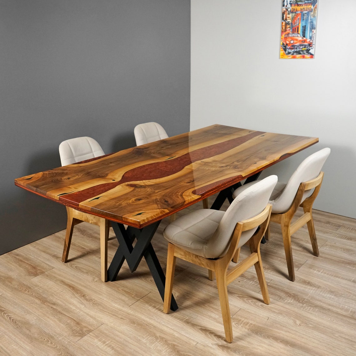Live edge walnut table with burgundy epoxy river seen from the corner, chairs at the near side