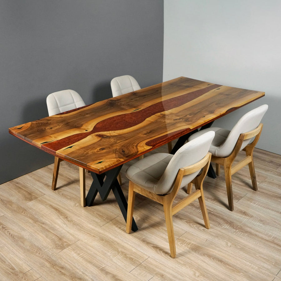 Amber live edge walnut dining table with a burgundy epoxy river and black metal legs, with four chairs