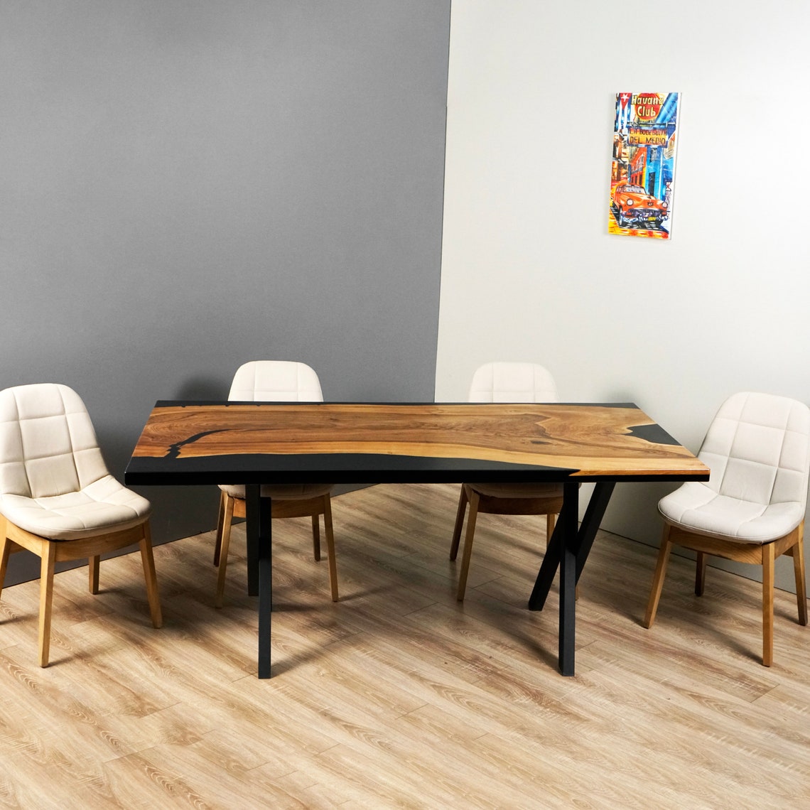 Straight-on side view of the walnut and black epoxy dining table showing its black metal legs