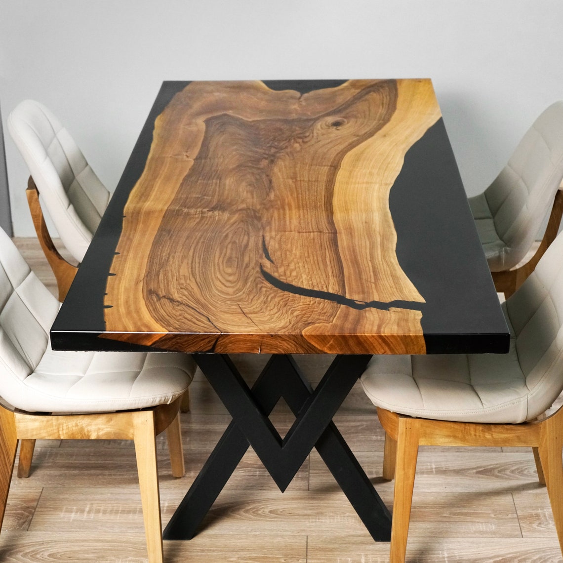 Live edge walnut dining table with black epoxy, top angle showing the grain and the epoxy-filled crack