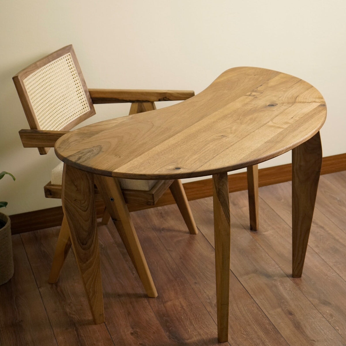 Angled top view of the bean shaped walnut desk showing the curved top and tapered legs