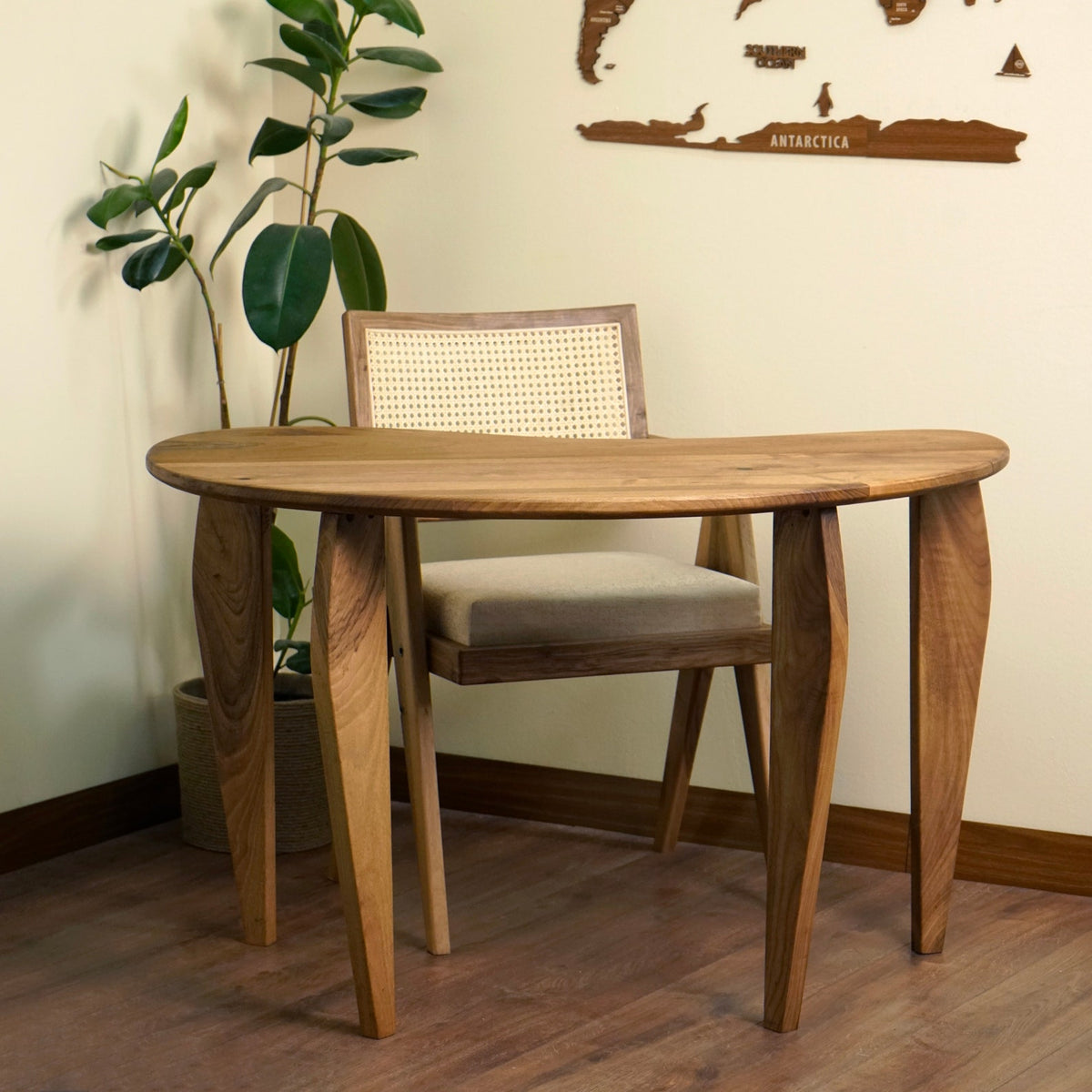 Side profile of the walnut desk showing the thin top and curved tapered legs