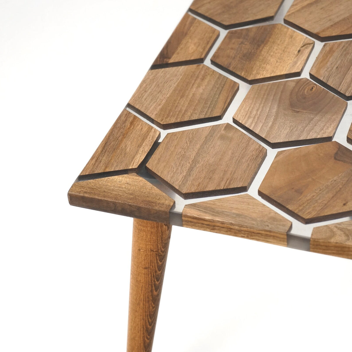 Close-up of the corner of the honeycomb epoxy coffee table top and a tapered leg