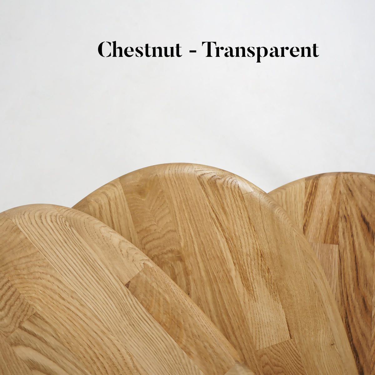 Close-up of the rounded chestnut nesting table tops and grain, labeled Chestnut - Transparent