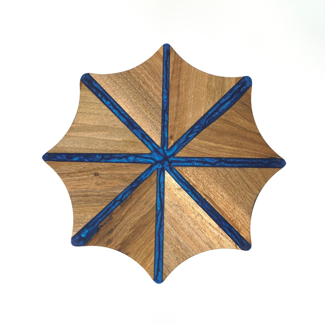 Top view of the walnut snowflake table with deep blue epoxy stripes radiating from the center