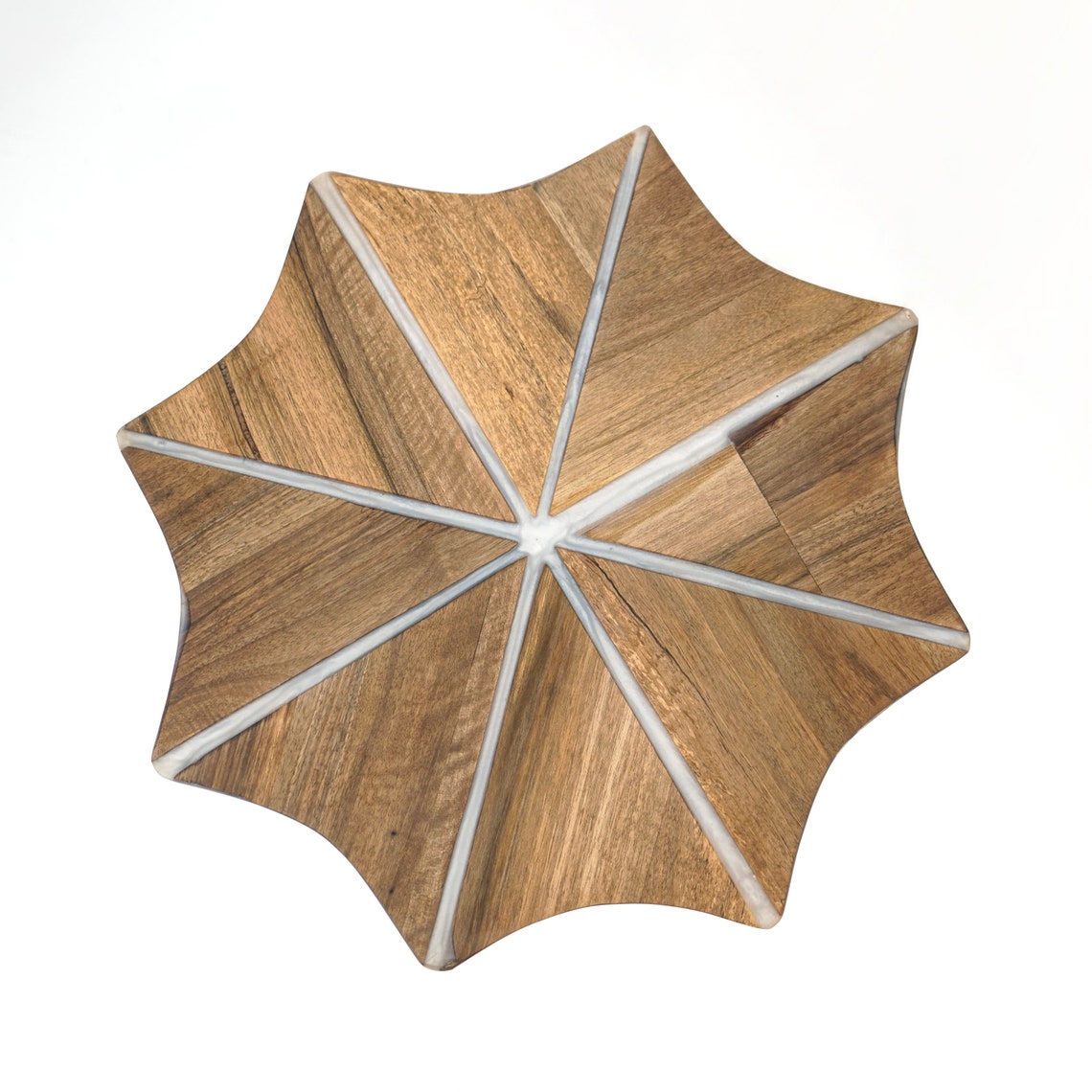 Top view of the walnut snowflake table with white epoxy stripes radiating from the center